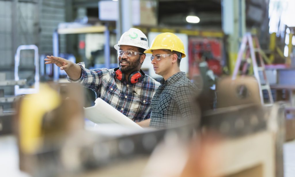 manufacturing professionals collaborating | processes of operational excellence
