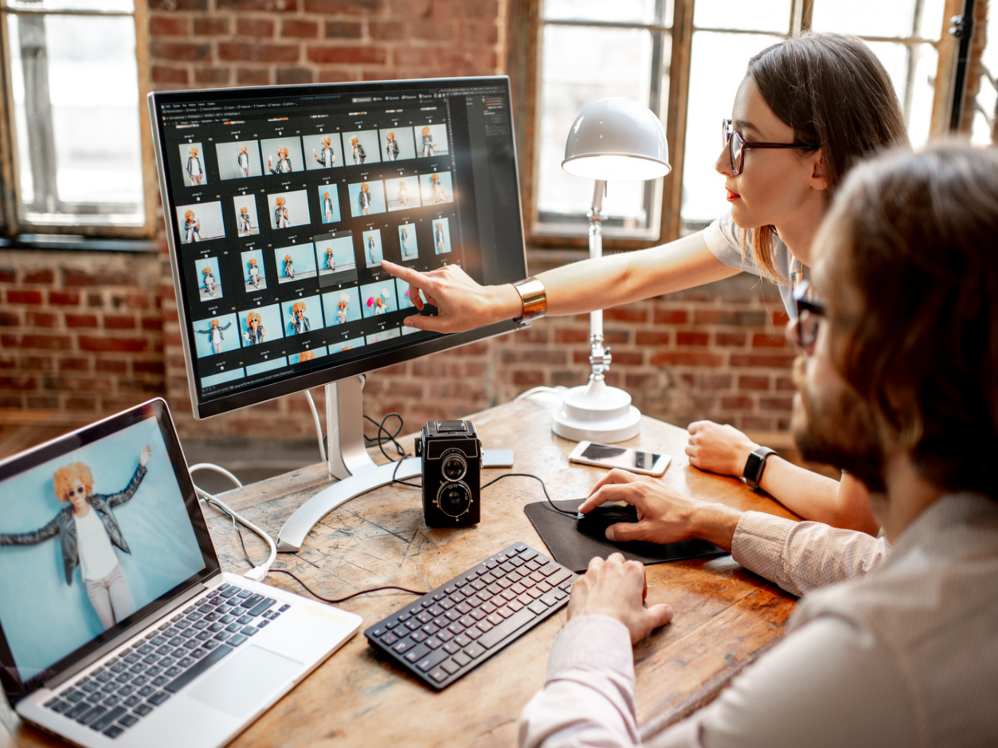 people at computer looking at digital photography after digital transformation